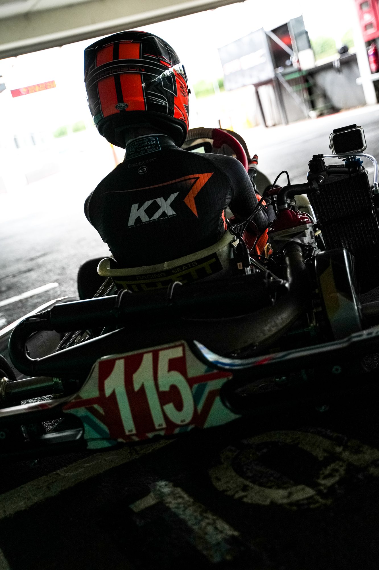 A racing helmet carrying the number 115